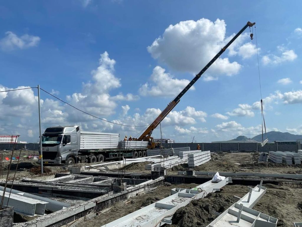 Steel structural components are transported to the site for installation and construction