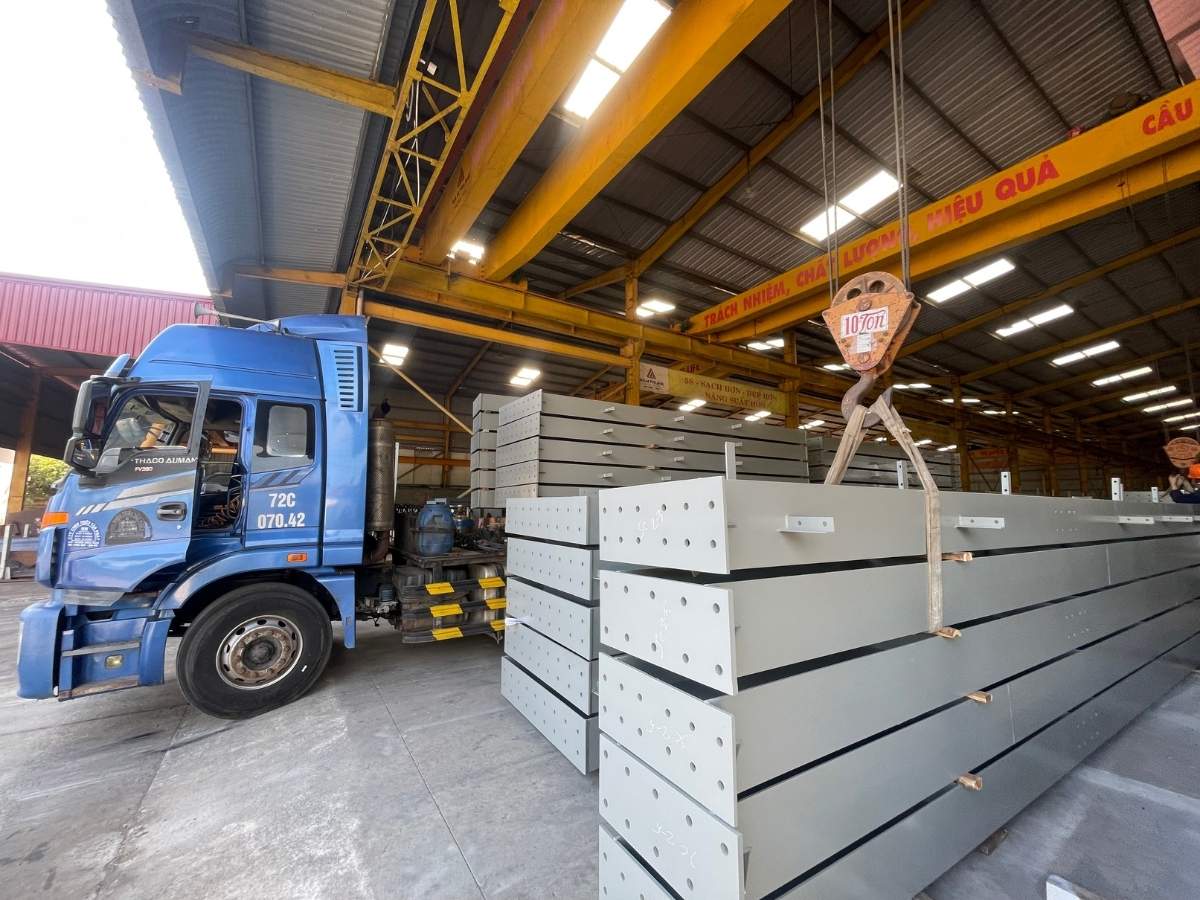 Transporting structural steel components from the factory to the construction site for installation